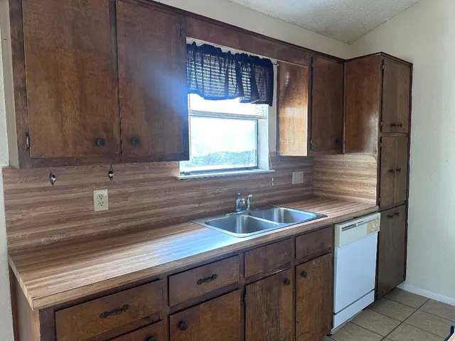 a kitchen with a sink and cabinets