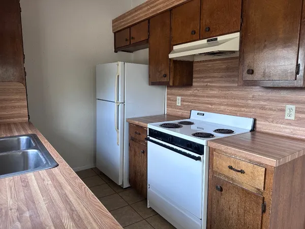a kitchen with a sink and a refrigerator