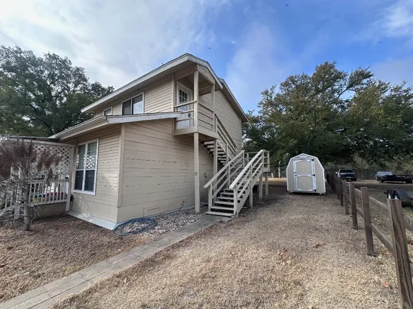a view of a house with a yard and roof
