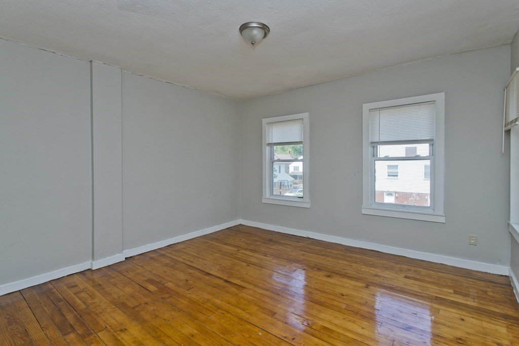 16 Nelson Avenue Springfield, MA 01109 - Photo 11 of 33 a view of an empty room with wooden floor and a window