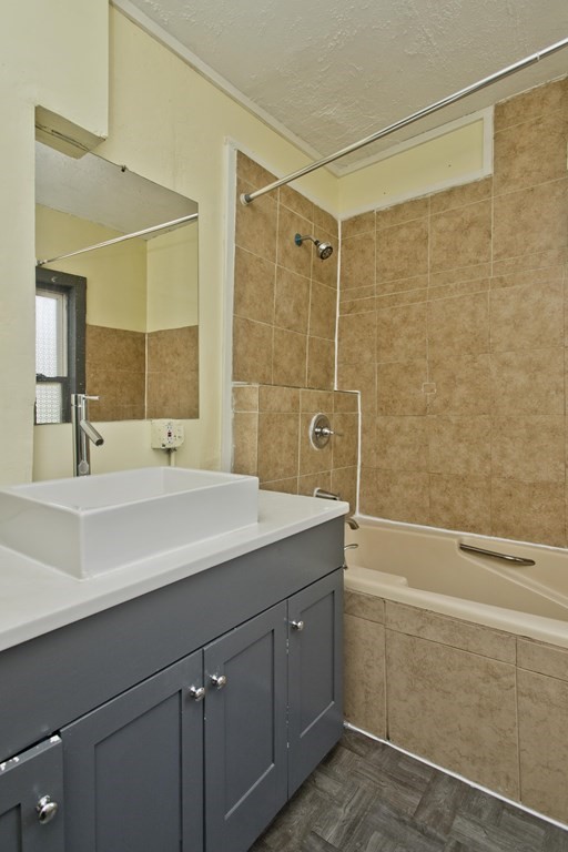 16 Nelson Avenue Springfield, MA 01109 - Photo 18 of 33 a bathroom with a shower sink and mirror