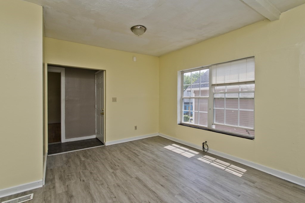 16 Nelson Avenue Springfield, MA 01109 - Photo 20 of 33 an empty room with wooden floor and windows