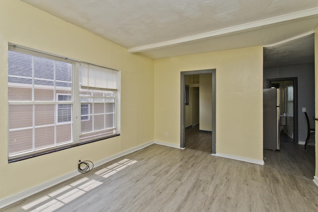 16 Nelson Avenue Springfield, MA 01109 - Photo 22 of 33 an empty room with wooden floor and windows
