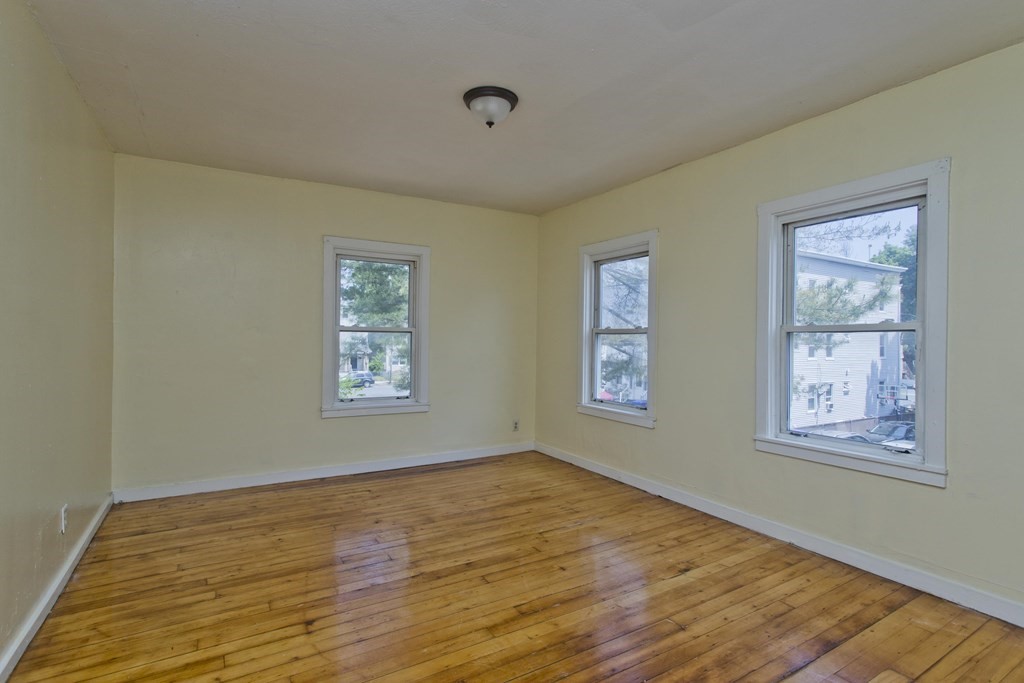 16 Nelson Avenue Springfield, MA 01109 - Photo 8 of 33 a view of an empty room with wooden floor and a window