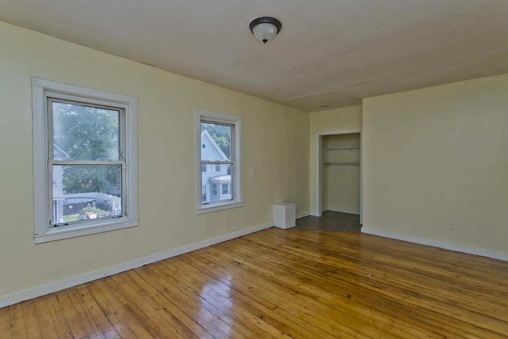 16 Nelson Avenue Springfield, MA 01109 - Photo 9 of 33 a view of empty room with wooden floor and fan