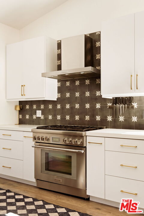 6151 Atoll Avenue Valley Glen, CA 91401 - Photo 18 of 58 a stove top oven sitting inside of a kitchen