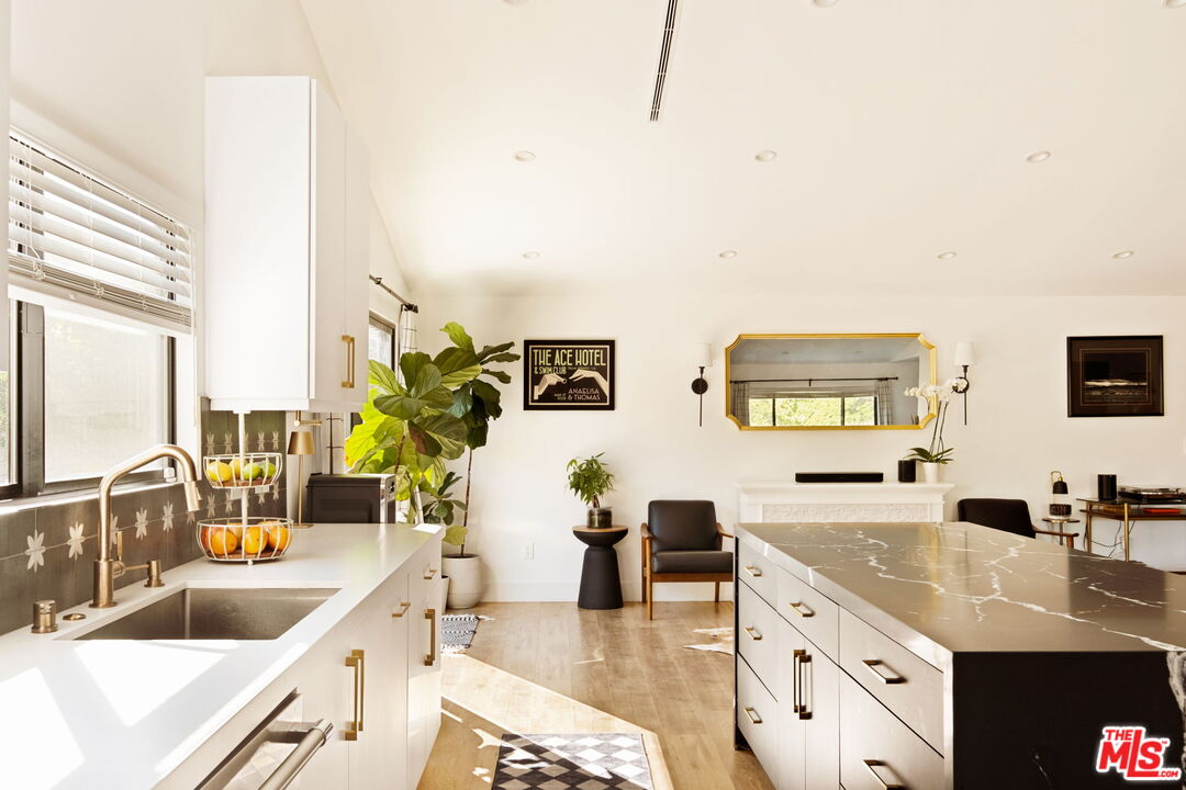 6151 Atoll Avenue Valley Glen, CA 91401 - Photo 20 of 58 a living room with stainless steel appliances kitchen island granite countertop a sink and a granite counter tops