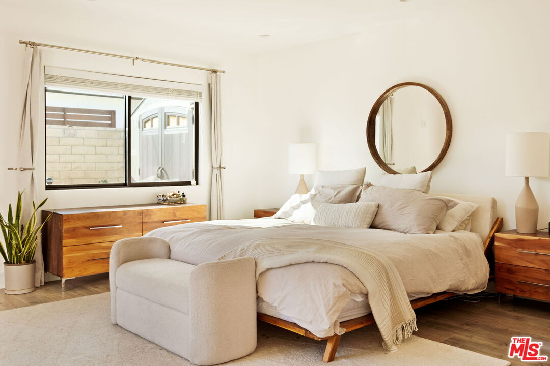 6151 Atoll Avenue Valley Glen, CA 91401 - Photo 22 of 58 a bedroom with a bed couch and mirror