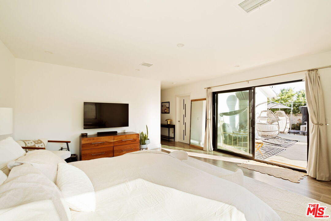 6151 Atoll Avenue Valley Glen, CA 91401 - Photo 24 of 58 a hotel room with a television and a bed