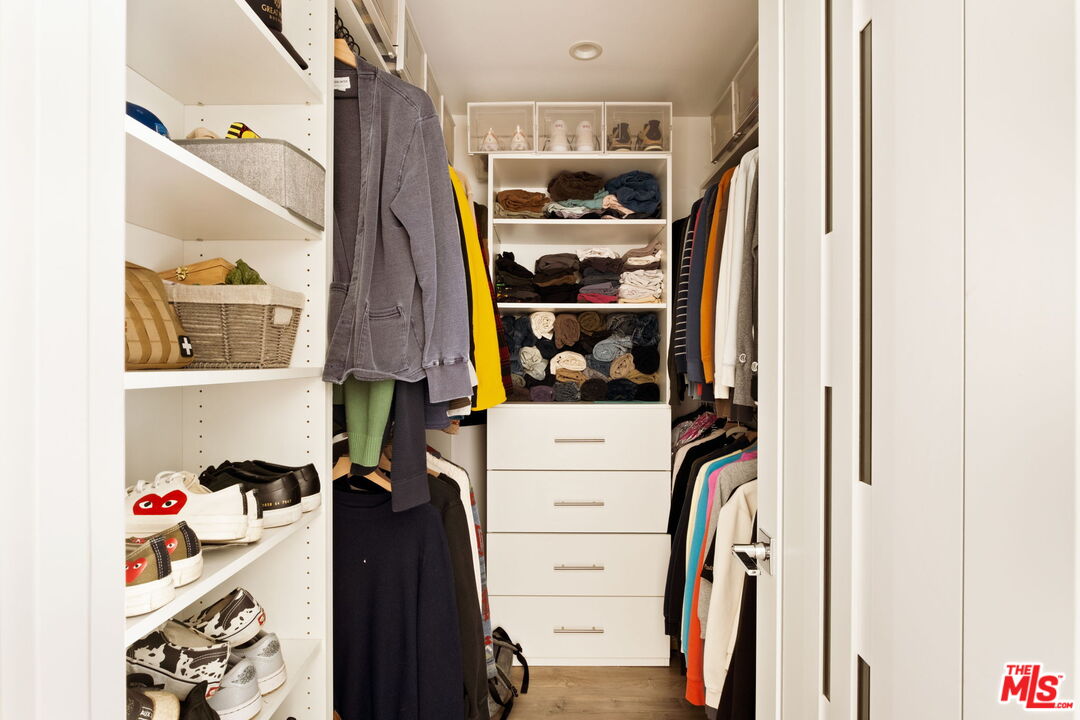6151 Atoll Avenue Valley Glen, CA 91401 - Photo 25 of 58 a view of walk in closet with clothes and shoes
