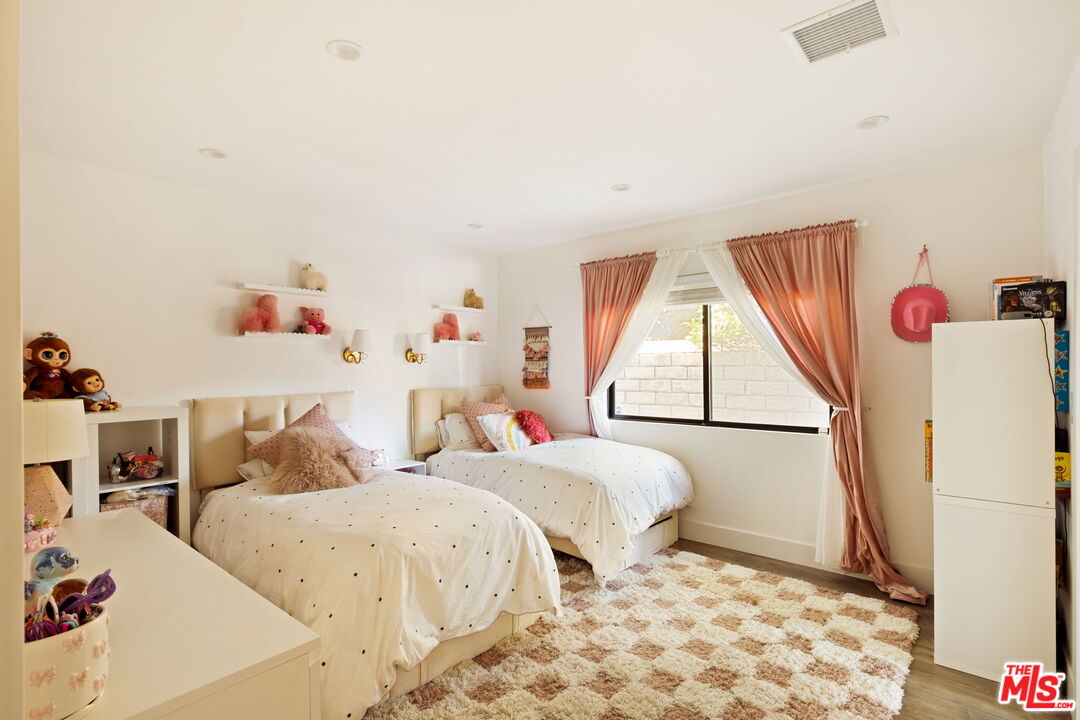 6151 Atoll Avenue Valley Glen, CA 91401 - Photo 28 of 58 a bedroom with two beds and a window