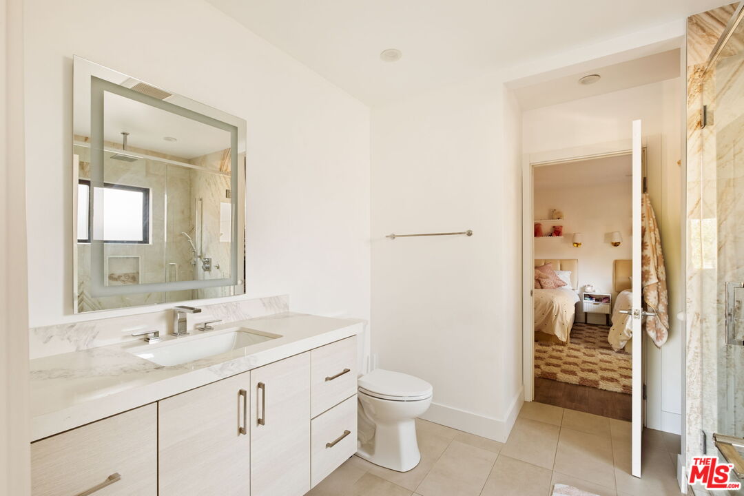 6151 Atoll Avenue Valley Glen, CA 91401 - Photo 29 of 58 a bathroom with a sink a toilet and shower