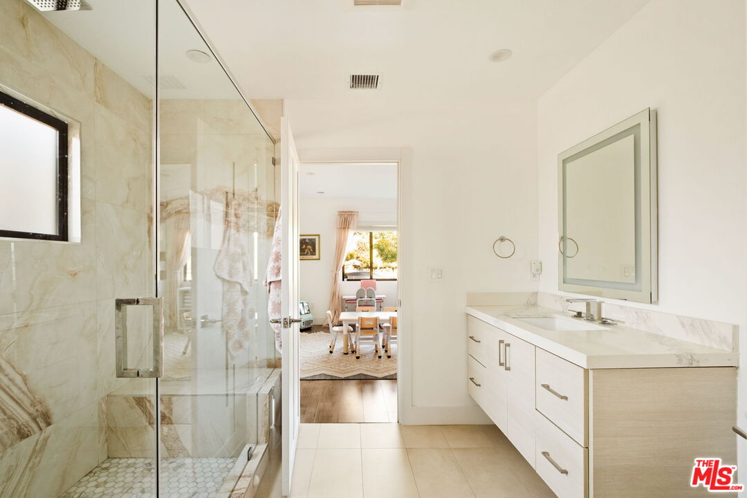 6151 Atoll Avenue Valley Glen, CA 91401 - Photo 30 of 58 a bathroom with a double vanity sink mirror and shower