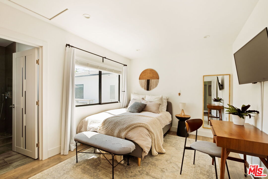 6151 Atoll Avenue Valley Glen, CA 91401 - Photo 34 of 58 a bedroom with a bed and a flat screen tv