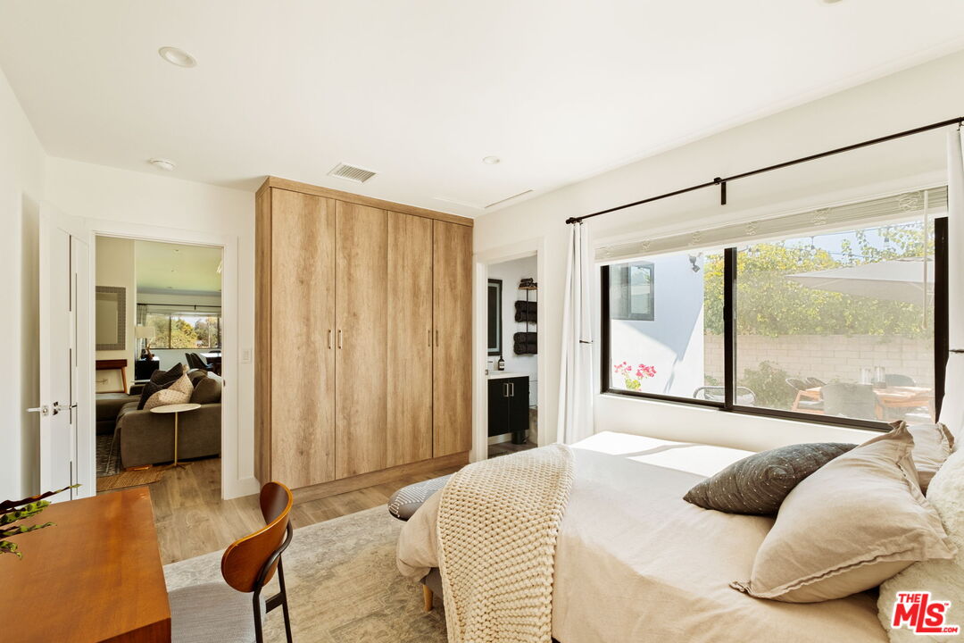 6151 Atoll Avenue Valley Glen, CA 91401 - Photo 35 of 58 a bedroom with a bed and a large window