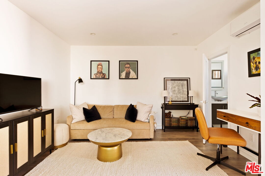 6151 Atoll Avenue Valley Glen, CA 91401 - Photo 42 of 58 a living room with furniture and a flat screen tv