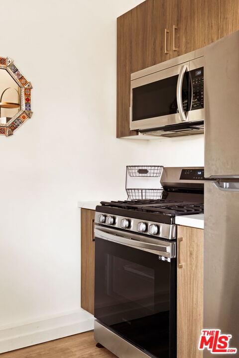 6151 Atoll Avenue Valley Glen, CA 91401 - Photo 45 of 58 a kitchen with a stove and a microwave
