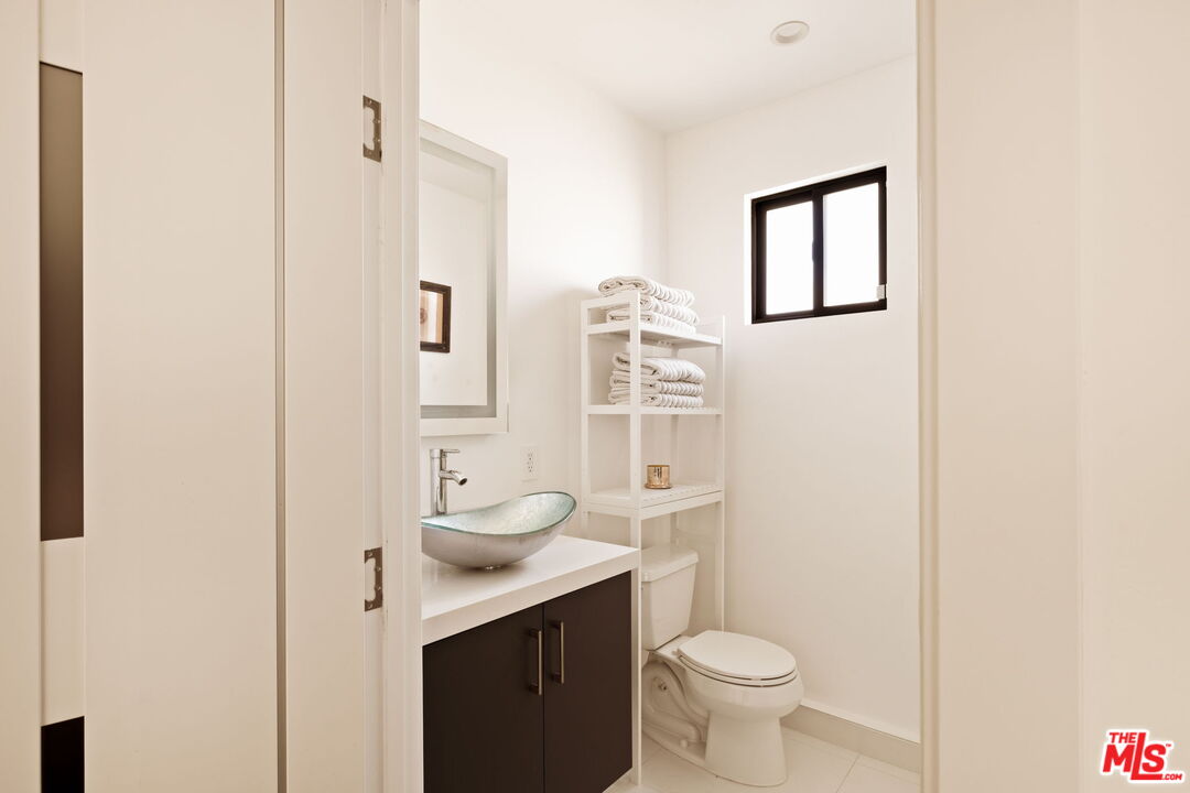 6151 Atoll Avenue Valley Glen, CA 91401 - Photo 46 of 58 a bathroom with a sink a toilet and shower