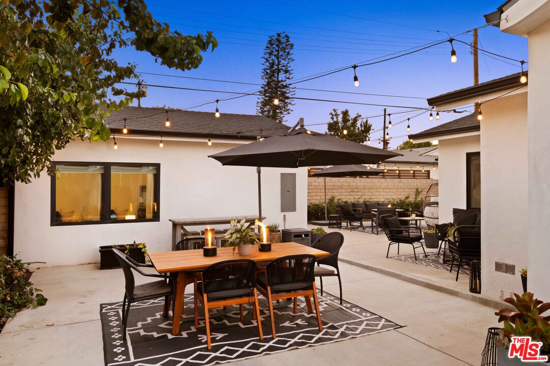 6151 Atoll Avenue Valley Glen, CA 91401 - Photo 51 of 58 a view of a dining table and chairs in patio