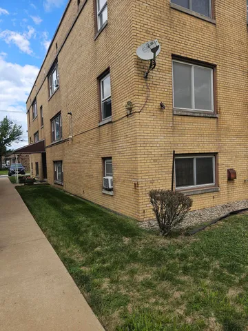 a brick building with a yard