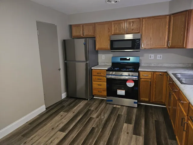 a kitchen with a refrigerator stove and microwave