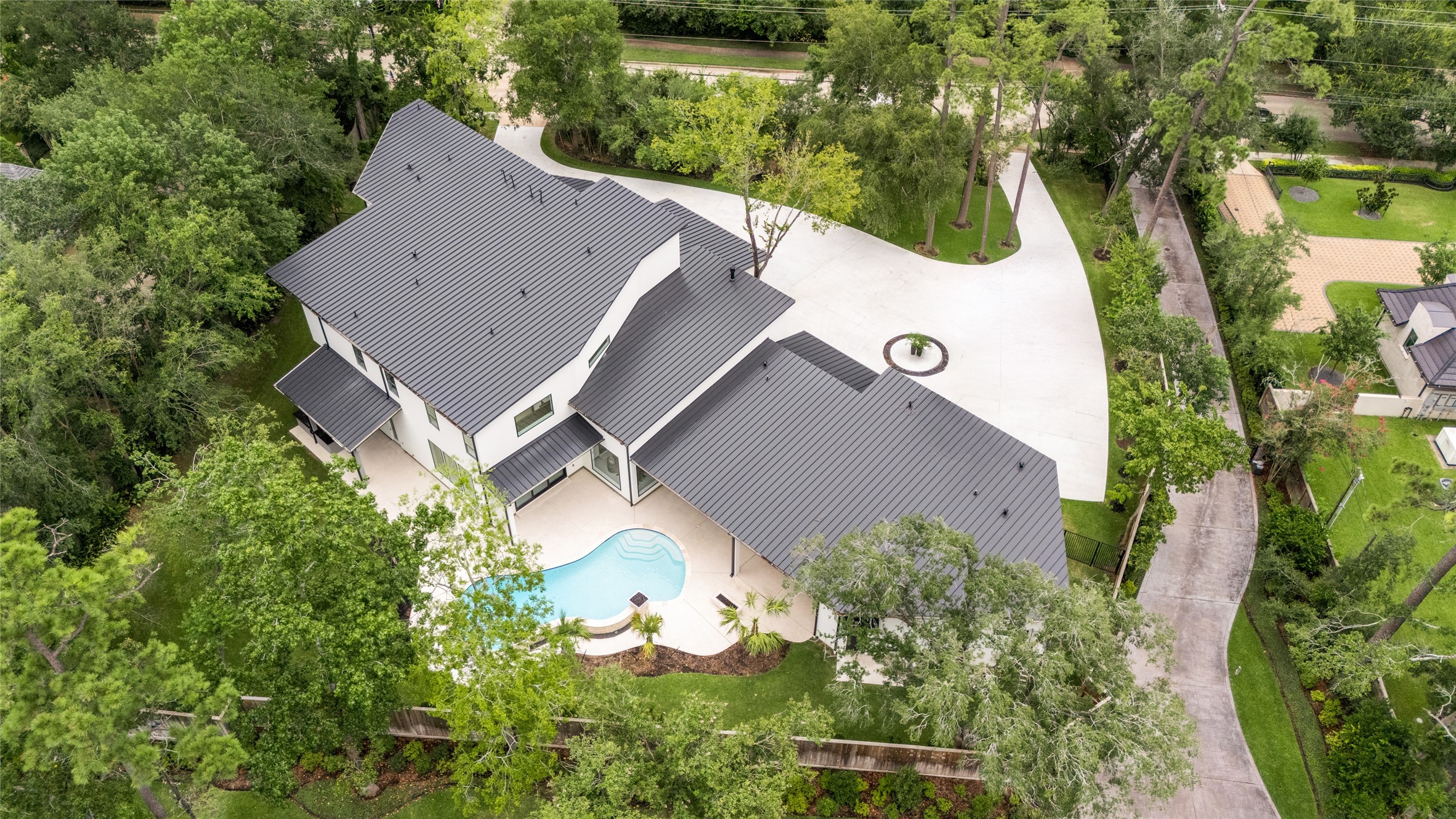 625 Piney Point Road Houston, TX 77024 - Photo 30 of 42 Situated on a 34,200 SF lot, this stunning contemporary home is crowned by an impressive standing seam metal roof, while mature trees envelop the lot, providing natural privacy.