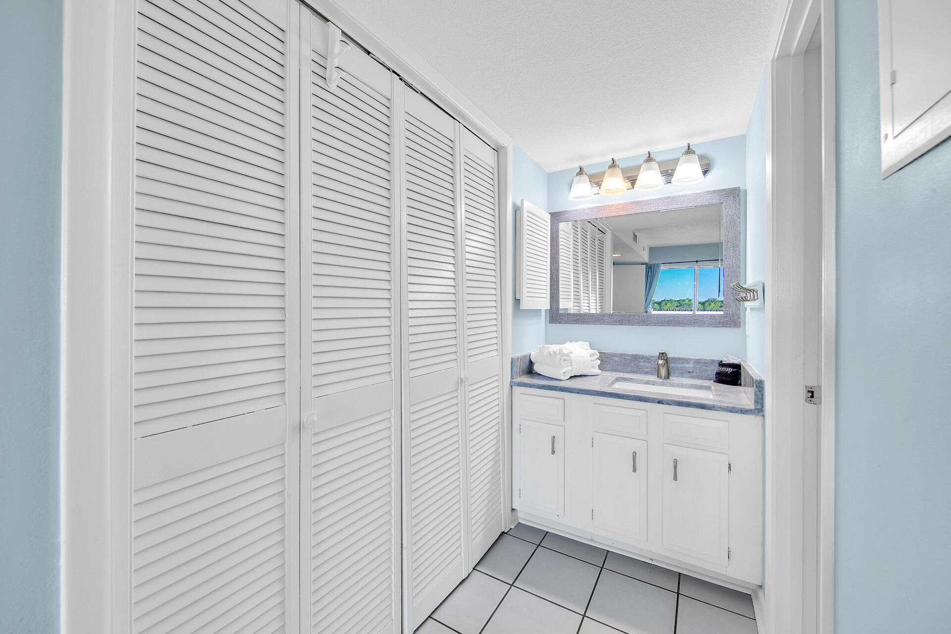 909 Santa Rosa Boulevard, Unit 561 Fort Walton Beach, FL 32548 - Photo 19 of 61 a bathroom with a granite countertop sink and a mirror