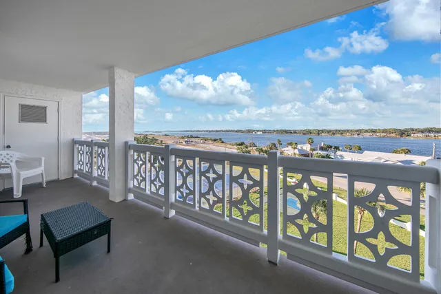 a view of a chairs and table in the balcony