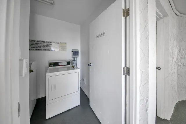 a view of a hallway to a livingroom with a fireplace