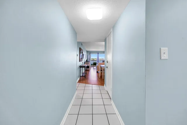 a kitchen with a refrigerator a stove top oven and cabinets
