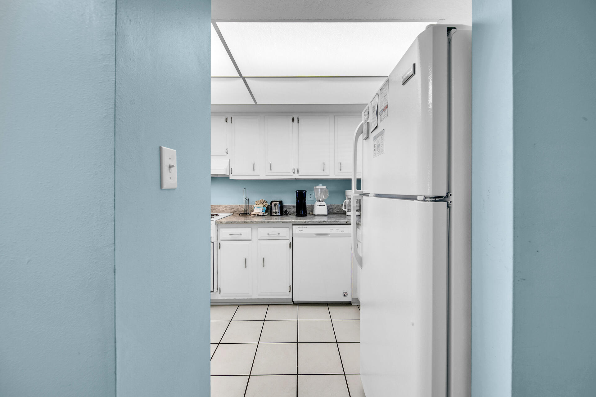 909 Santa Rosa Boulevard, Unit 561 Fort Walton Beach, FL 32548 - Photo 29 of 61 a kitchen with a refrigerator a stove top oven and cabinets