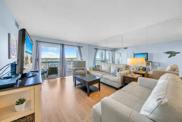 a living room with furniture and large windows