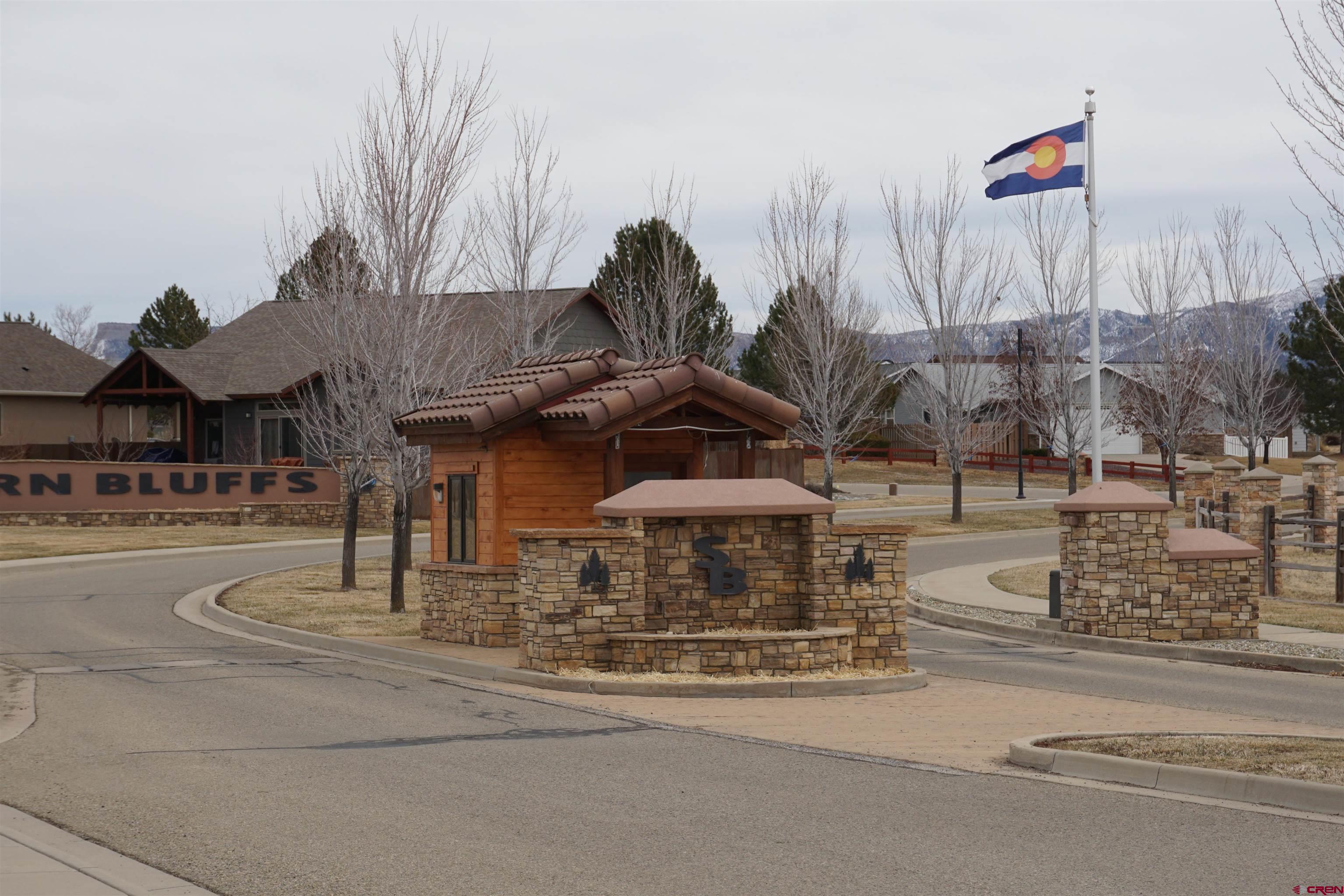 1109 Bluffs Boulevard Cortez, CO 81321 - Photo 2 of 8 a view of parked cars in front of building