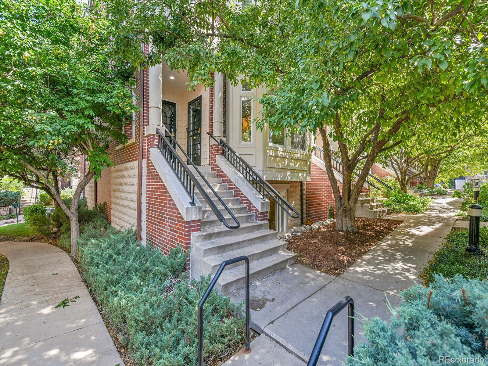 a front view of a house with a tree