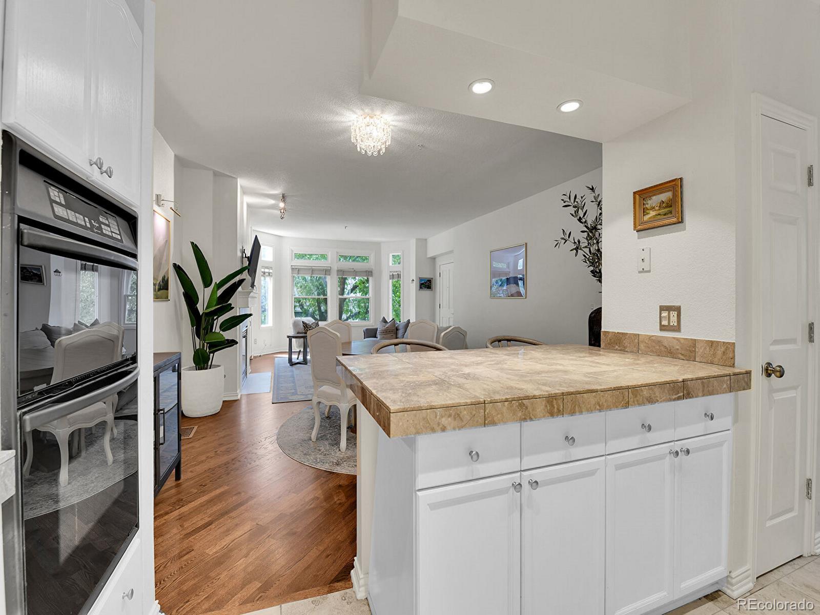 45 Jackson Street, Unit D Denver, CO 80206 - Photo 11 of 29 a bedroom with a bed and a dresser with wooden floor