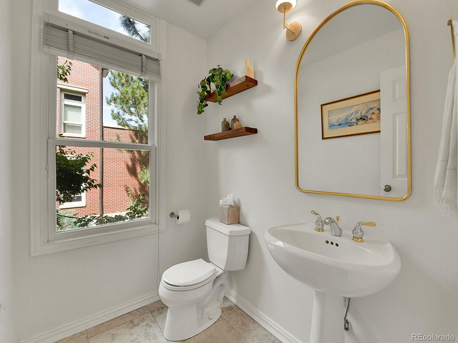 45 Jackson Street, Unit D Denver, CO 80206 - Photo 12 of 29 a bathroom with a toilet a sink and mirror