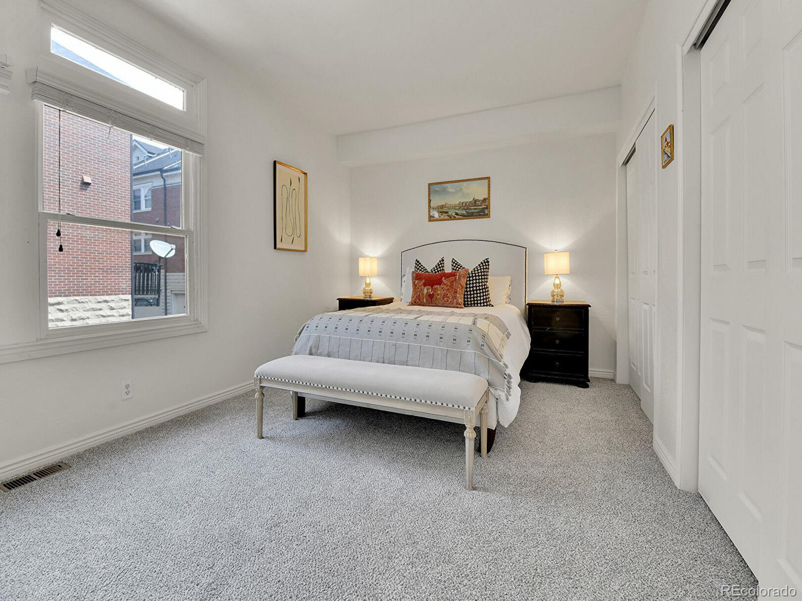 45 Jackson Street, Unit D Denver, CO 80206 - Photo 13 of 29 a bedroom with a bed and a table