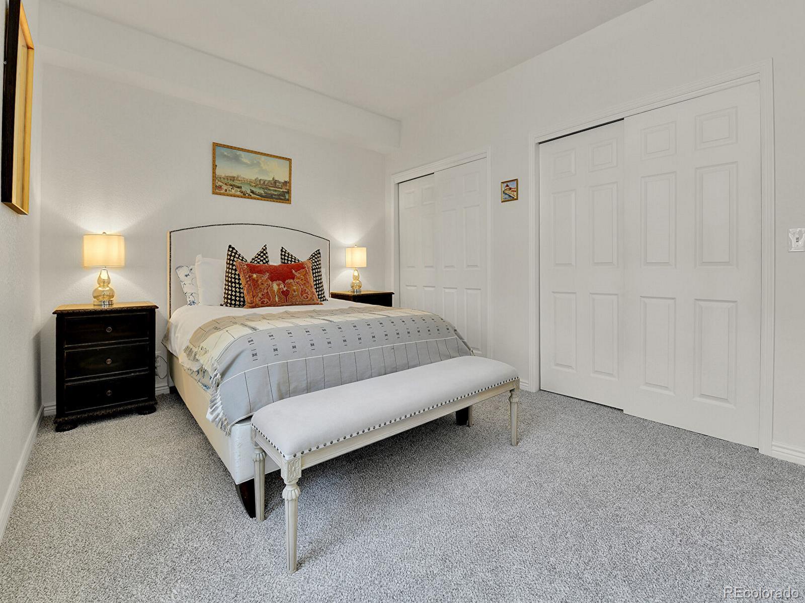 45 Jackson Street, Unit D Denver, CO 80206 - Photo 14 of 29 a bedroom with a bed and a night stand