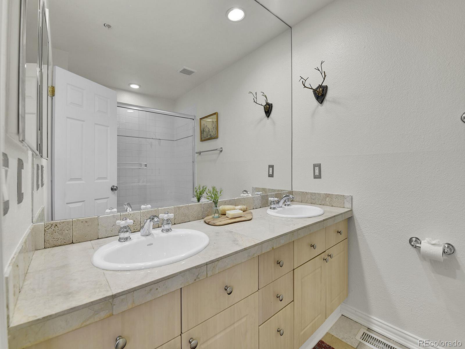45 Jackson Street, Unit D Denver, CO 80206 - Photo 16 of 29 a bathroom with a granite countertop sink and a mirror