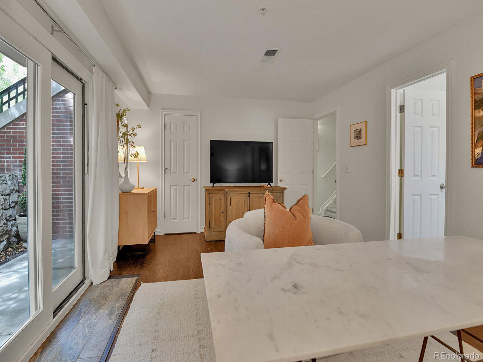 45 Jackson Street, Unit D Denver, CO 80206 - Photo 20 of 29 a bedroom with a large bed and a flat screen tv