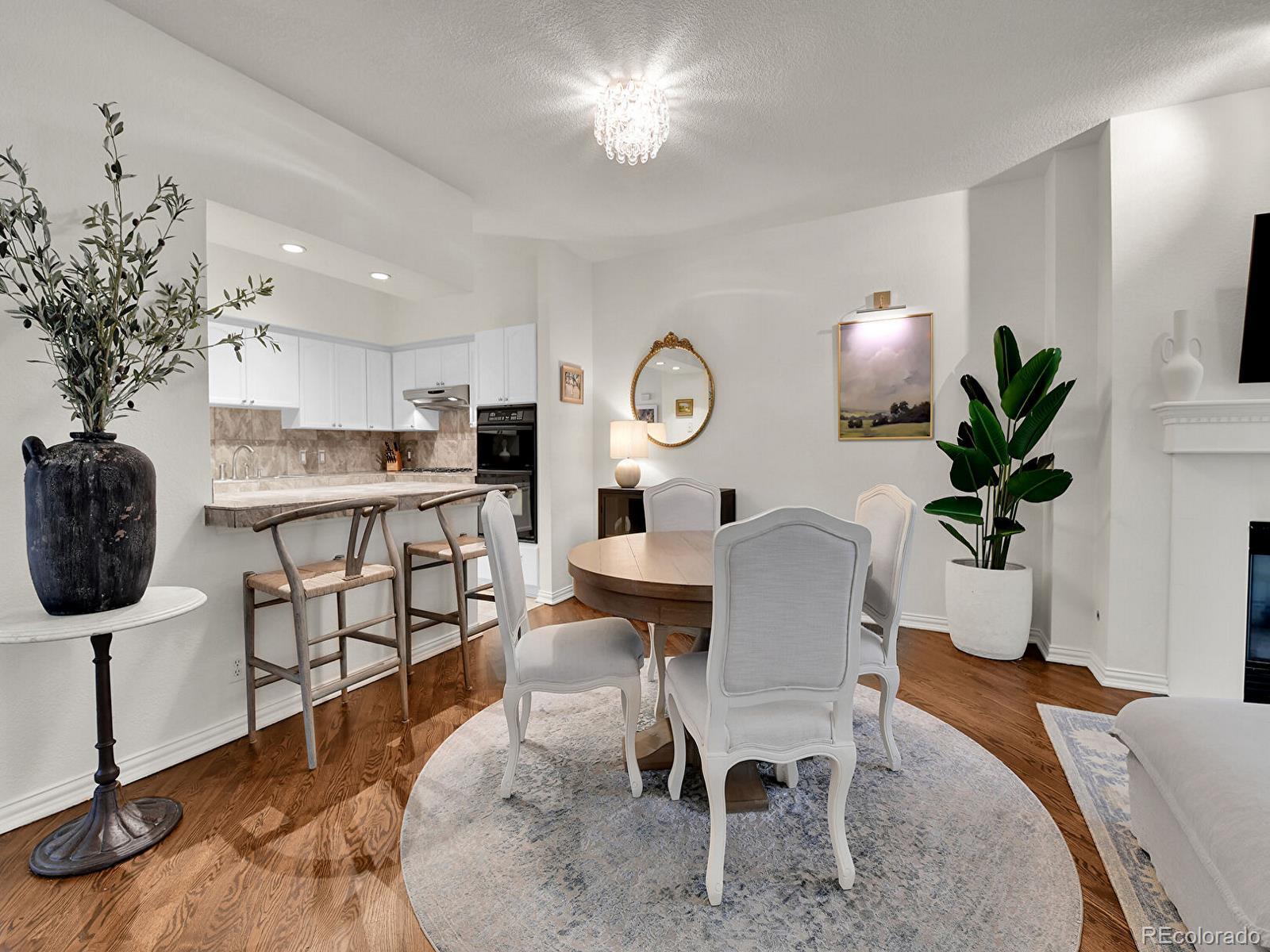 45 Jackson Street, Unit D Denver, CO 80206 - Photo 6 of 29 a view of a dining room with furniture and wooden floor