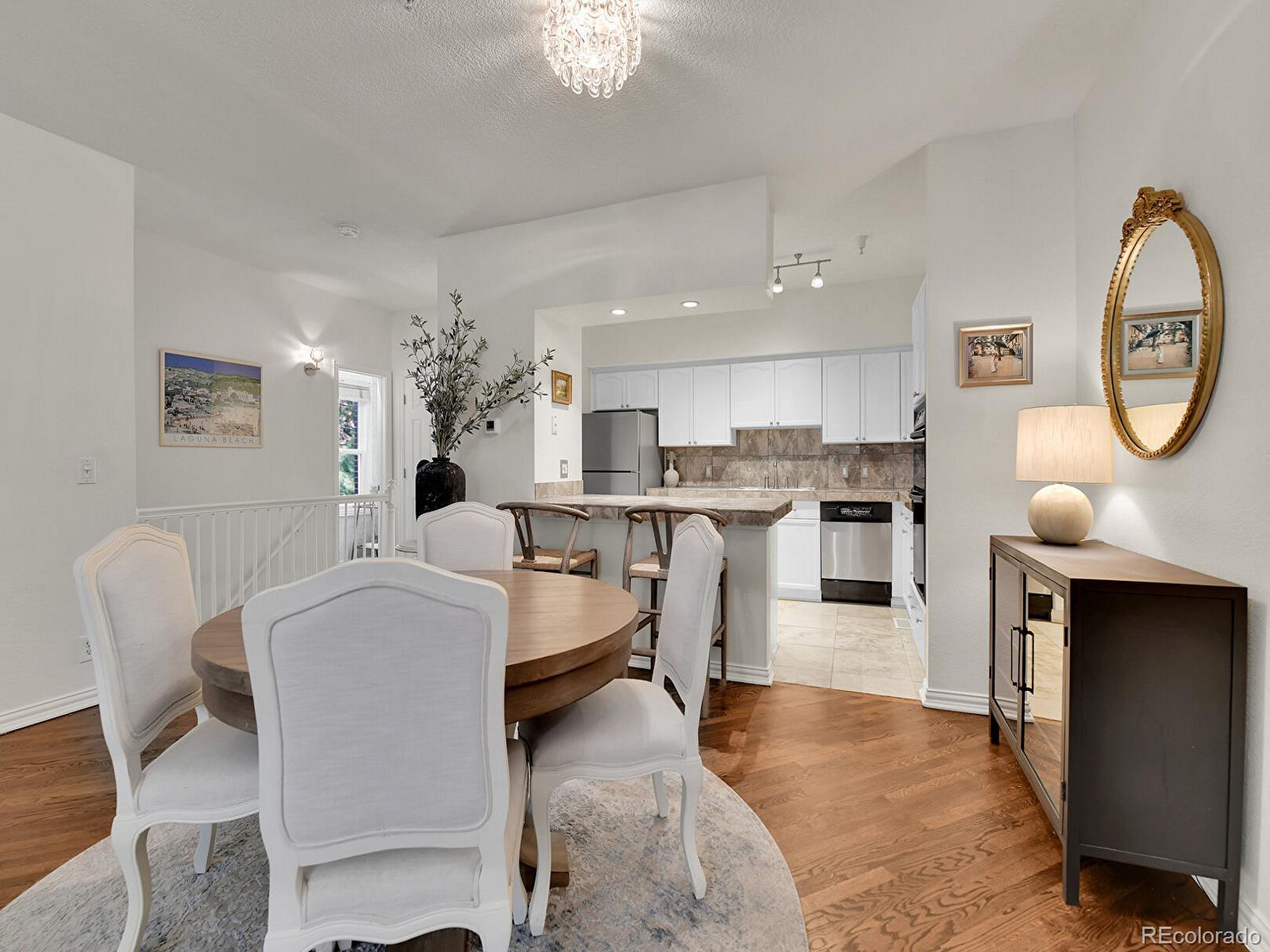45 Jackson Street, Unit D Denver, CO 80206 - Photo 7 of 29 a living room with stainless steel appliances furniture a chandelier and a kitchen view