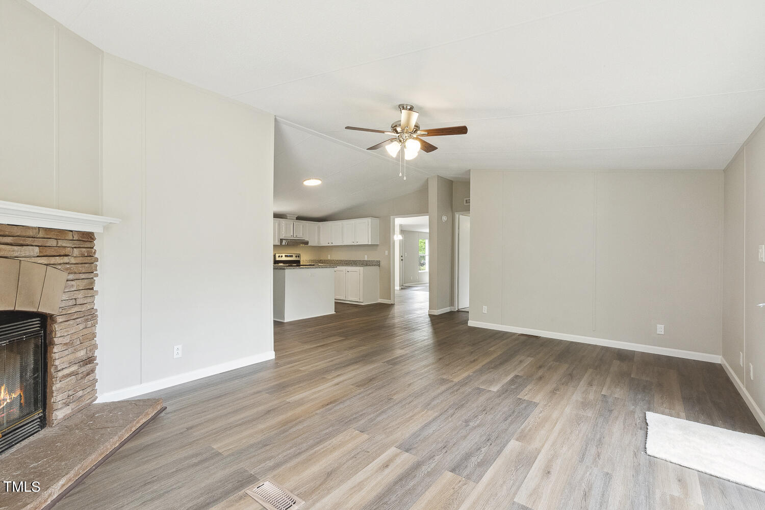 3820 Morton-Pulliam Road Roxboro, NC 27574 - Photo 17 of 37 a view of an empty room with a fireplace and wooden floor
