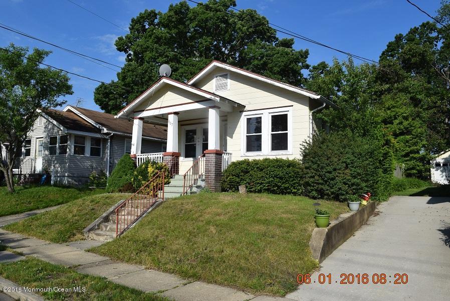 807 Ridge Avenue Neptune City, NJ 07753 - Photo 1 of 15 a front view of a house with a yard