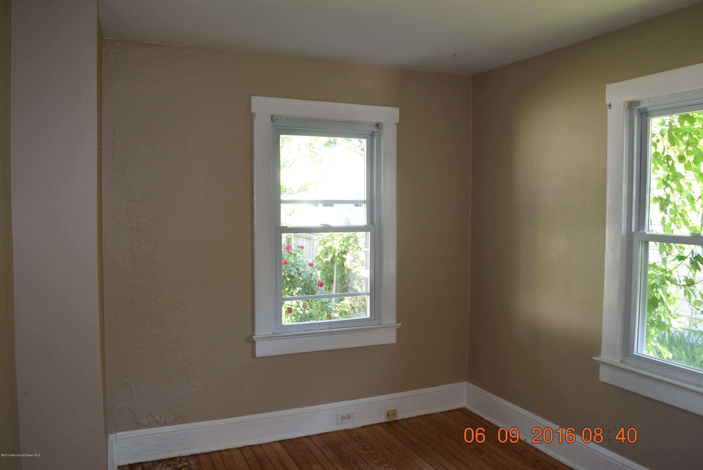 807 Ridge Avenue Neptune City, NJ 07753 - Photo 13 of 15 an empty room with wooden floor and windows