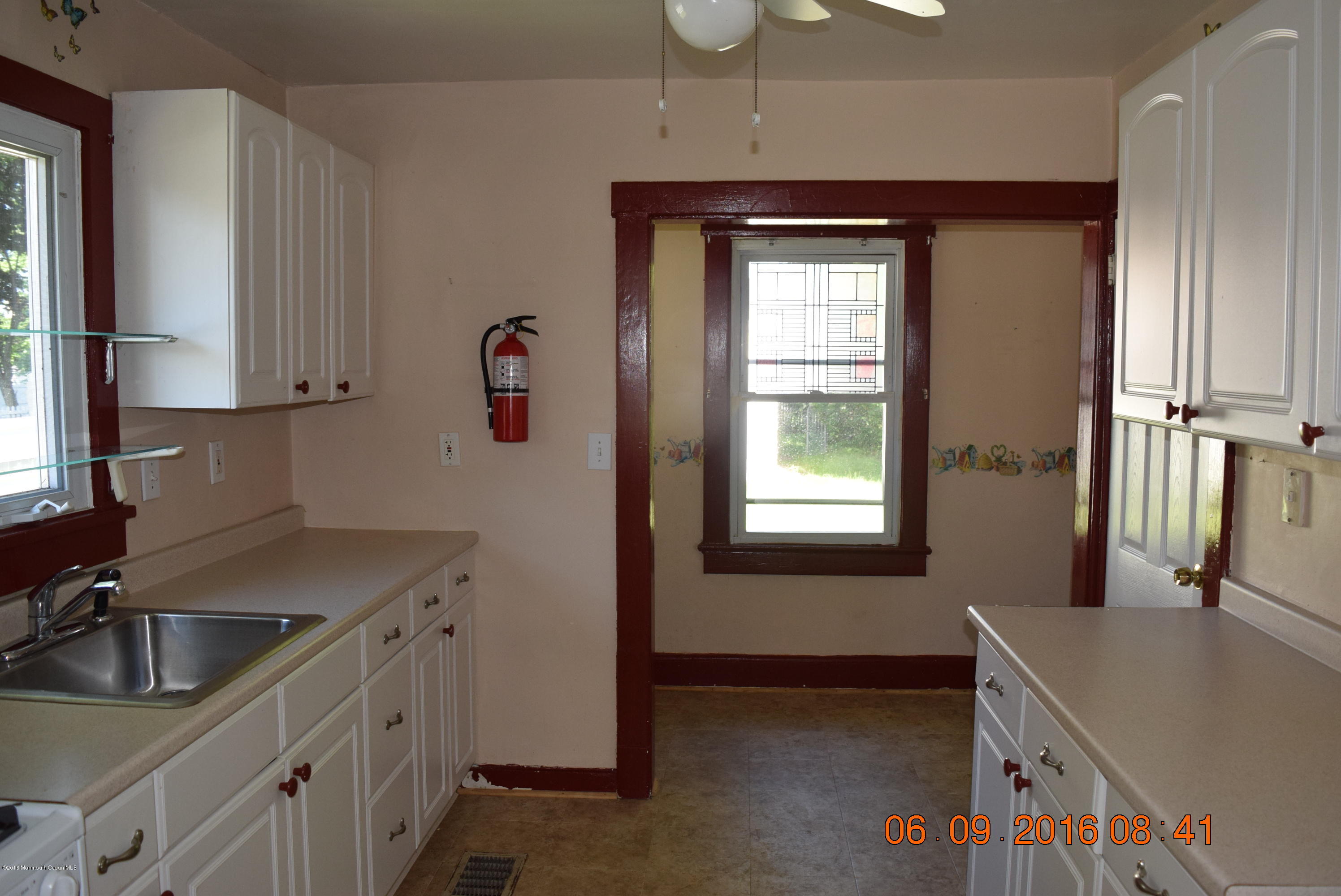 807 Ridge Avenue Neptune City, NJ 07753 - Photo 14 of 15 a kitchen with stainless steel appliances granite countertop a sink stove and refrigerator