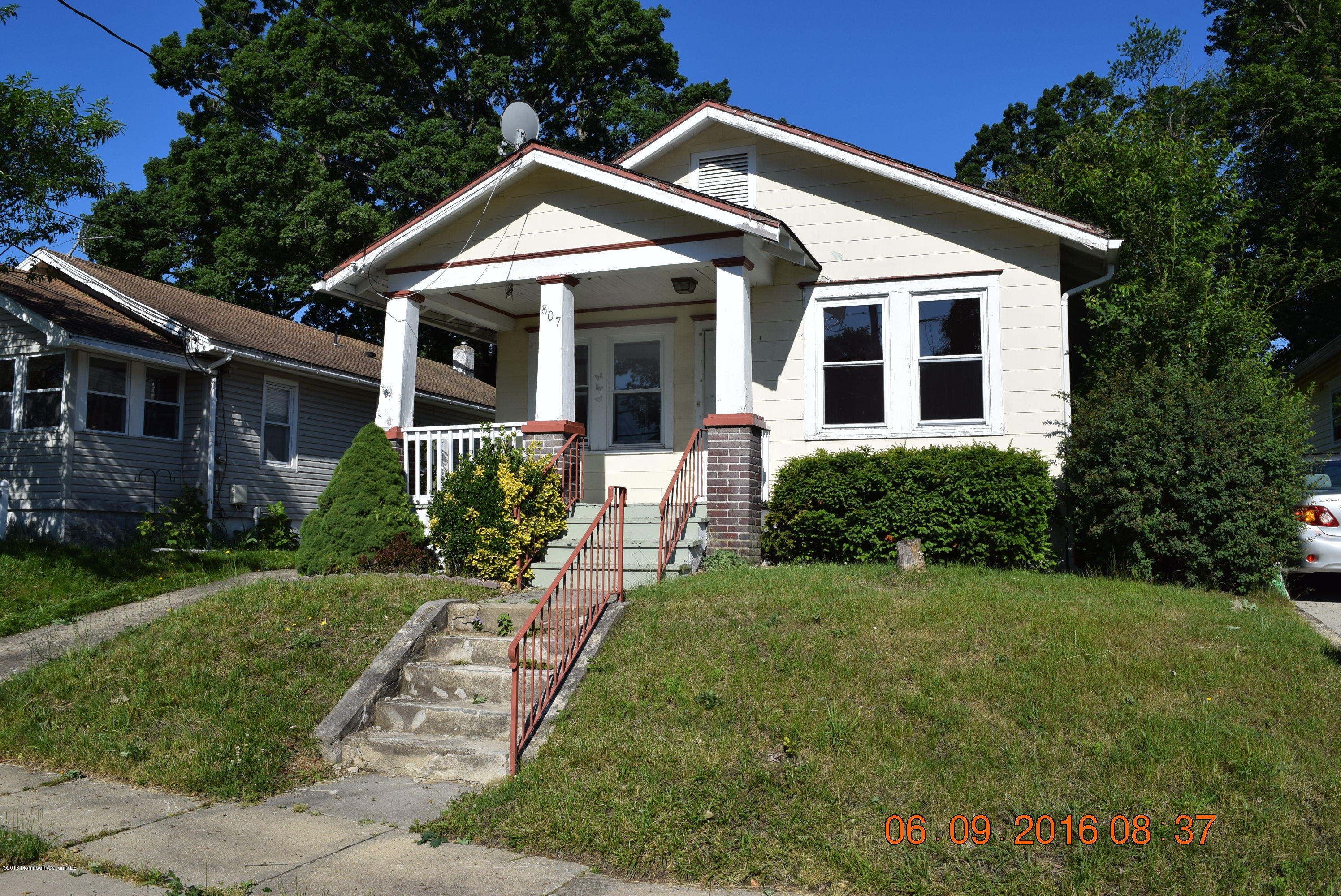 807 Ridge Avenue Neptune City, NJ 07753 - Photo 2 of 15 a front view of a house with a yard