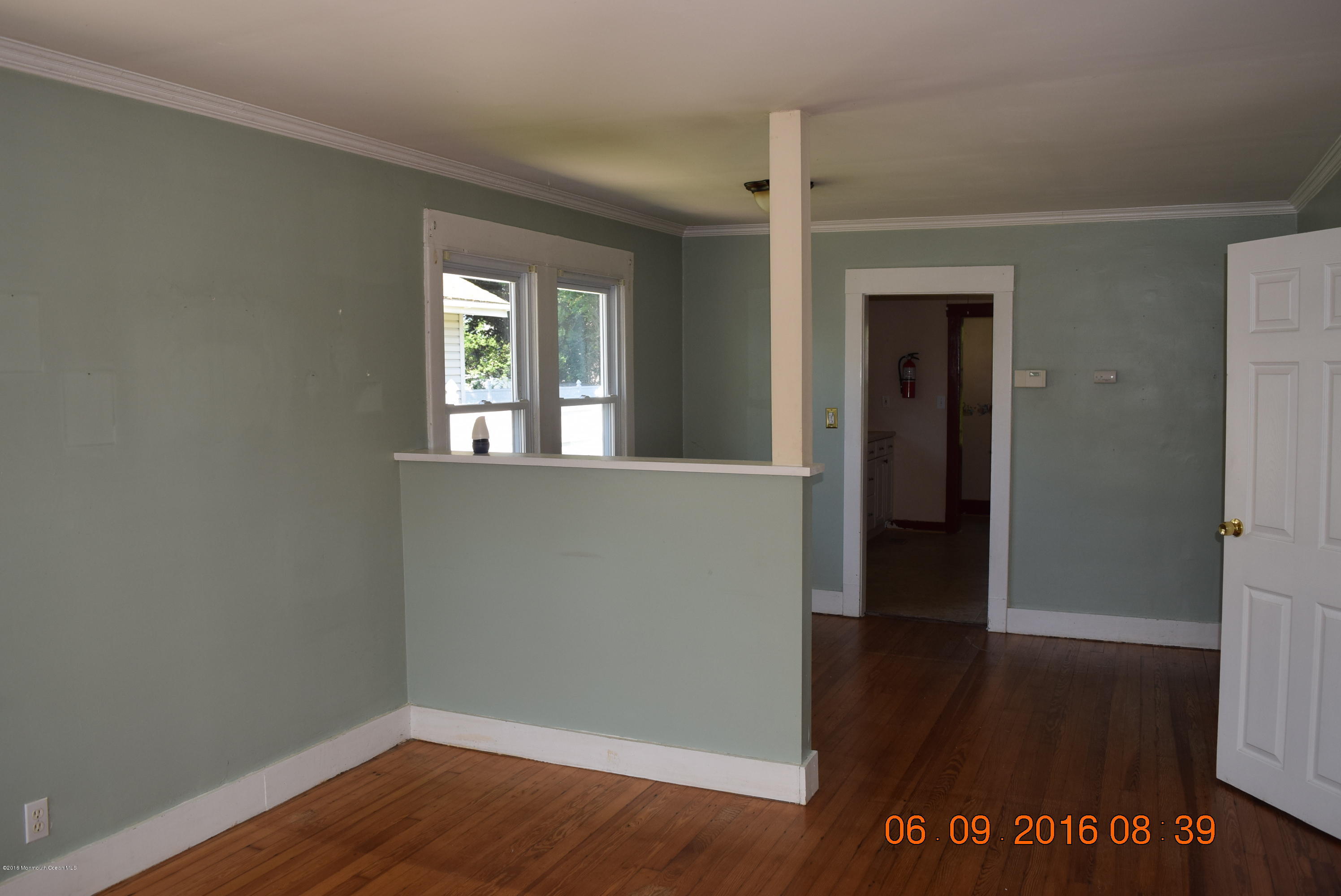807 Ridge Avenue Neptune City, NJ 07753 - Photo 7 of 15 wooden floor in an empty room with a window