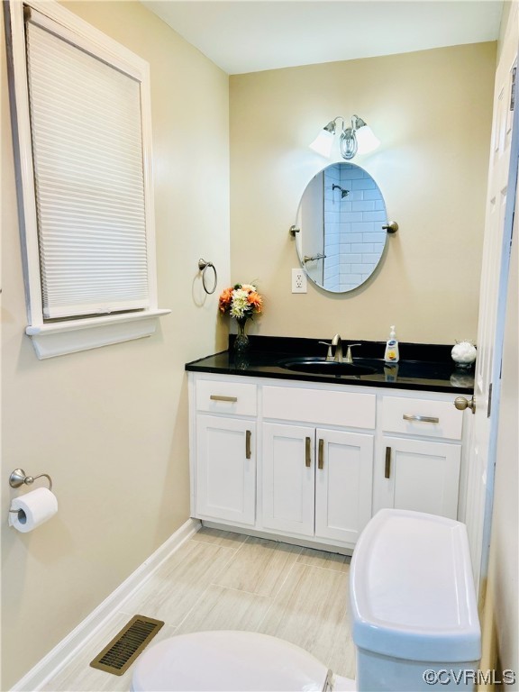 4416 Treely Road Chester, VA 23831 - Photo 9 of 22 a bathroom with a sink and a mirror