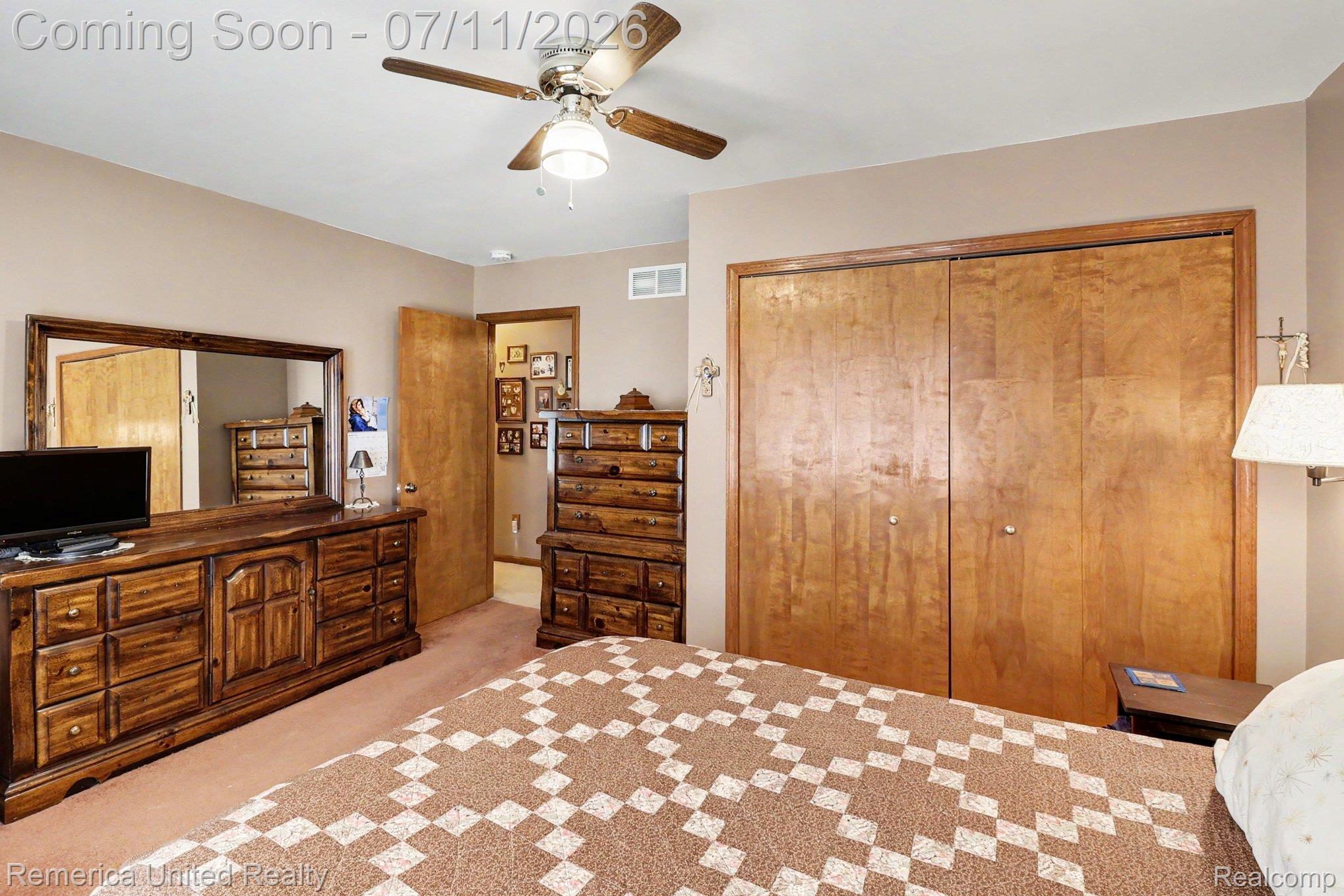136 Endicott Howell, MI 48843 - Photo 17 of 28 Room featuring wood-finish bi-fold closet doors, a ceiling fan with integrated lighting, and carpeted flooring